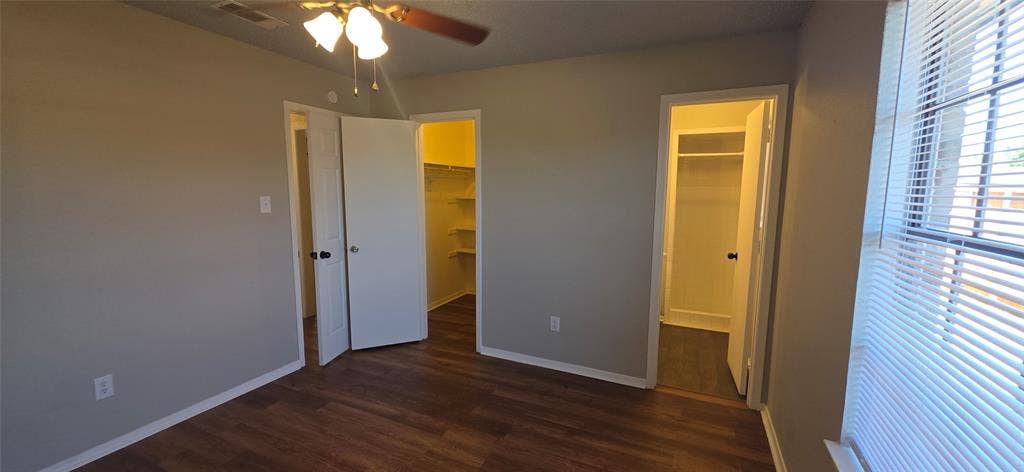 235 Vista Way, Benbrook, TX 76126 Wood-finish flooring throughout, light neutral wall paint, ceiling fan with integrated lighting, and dual closet spaces