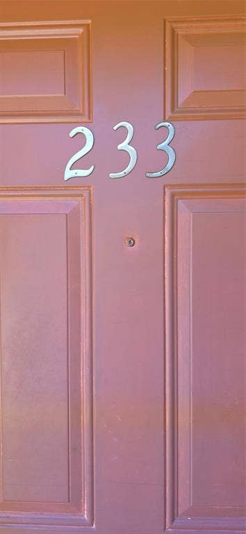 235 Vista Way, Benbrook, TX 76126 Panel-style entry door with a peephole and decorative house numbers