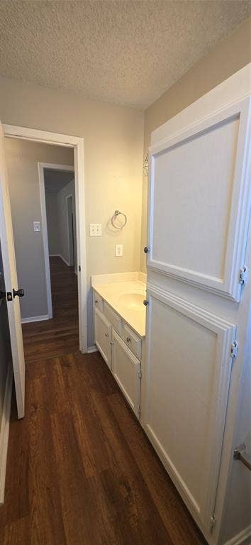 235 Vista Way, Benbrook, TX 76126 White vanity with integrated sink, wood-finish flooring, and white built-in cabinetry