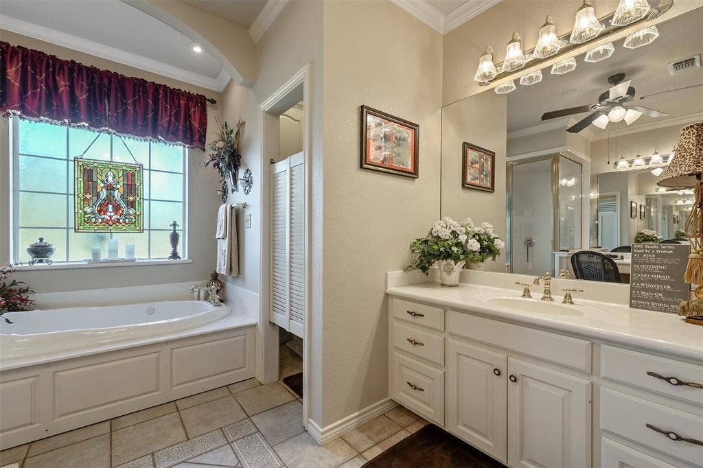 126 E Post Oak, Frankston, TX 75763 Spacious bathroom featuring a soaking tub, dual vanity with extensive counter space, and a separate shower enclosure