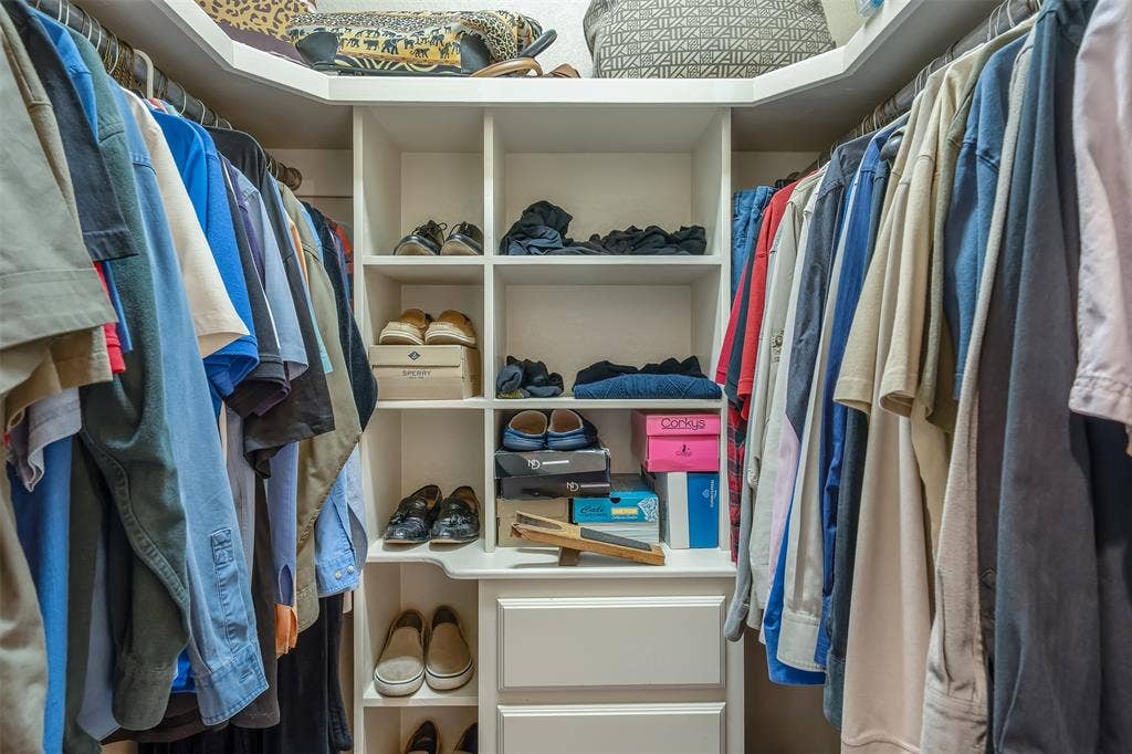 126 E Post Oak, Frankston, TX 75763 Custom closet system featuring white built-in shelving, hanging rods, and integrated drawers