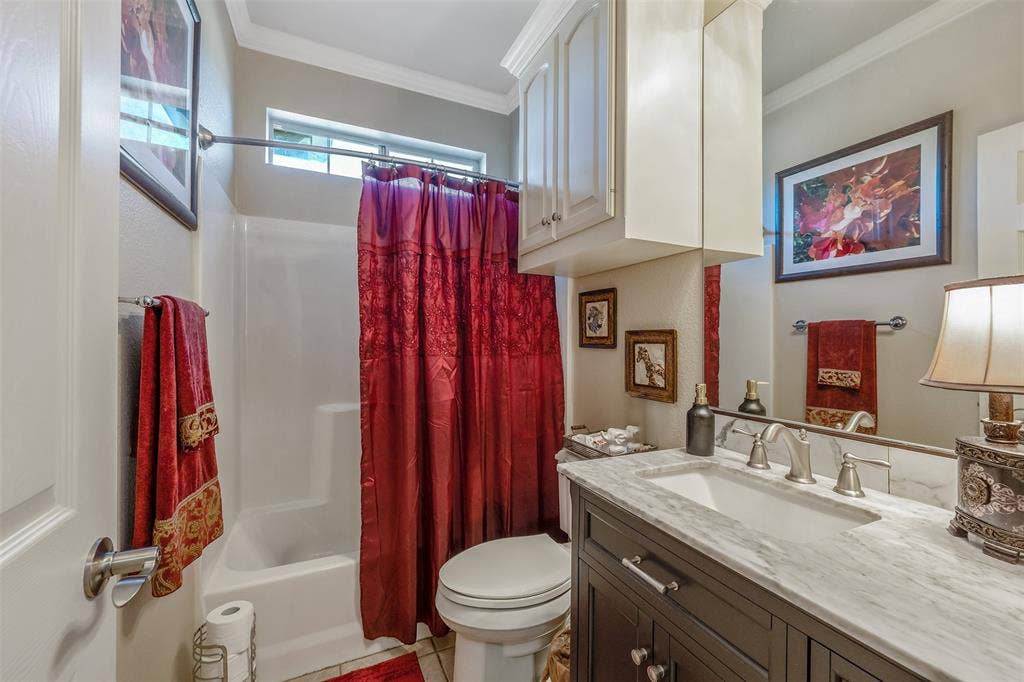 126 E Post Oak, Frankston, TX 75763 Full bathroom featuring a single vanity with a stone countertop, an undermount sink, and a built-in tub with shower