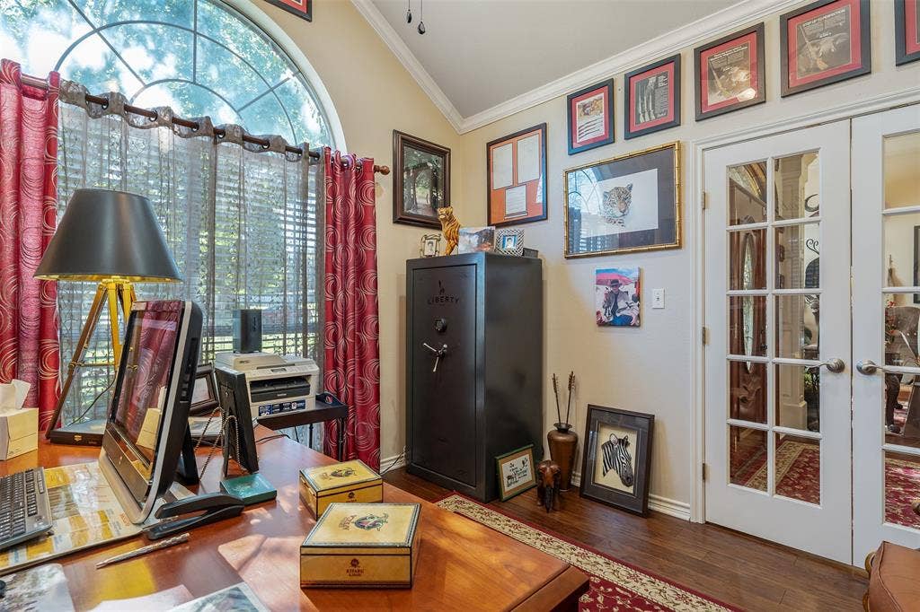 126 E Post Oak, Frankston, TX 75763 Room featuring a large arched window with blinds, wood-finish flooring, and light-toned walls