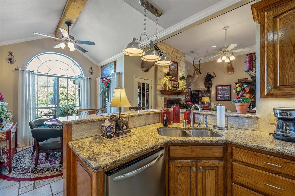 126 E Post Oak, Frankston, TX 75763 Kitchen featuring a double basin stainless steel sink, granite countertops, wood cabinetry, and a dishwasher