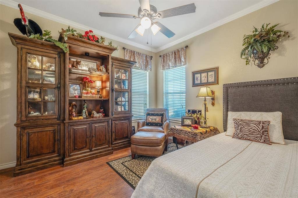 126 E Post Oak, Frankston, TX 75763 Warm-toned room featuring a comprehensive built-in media center with glass-front display cabinets and integrated lighting