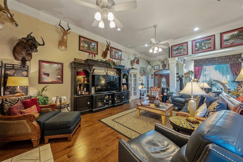 126 E Post Oak, Frankston, TX 75763 Spacious living area featuring wood-finish flooring, recessed lighting, and multiple ceiling fans