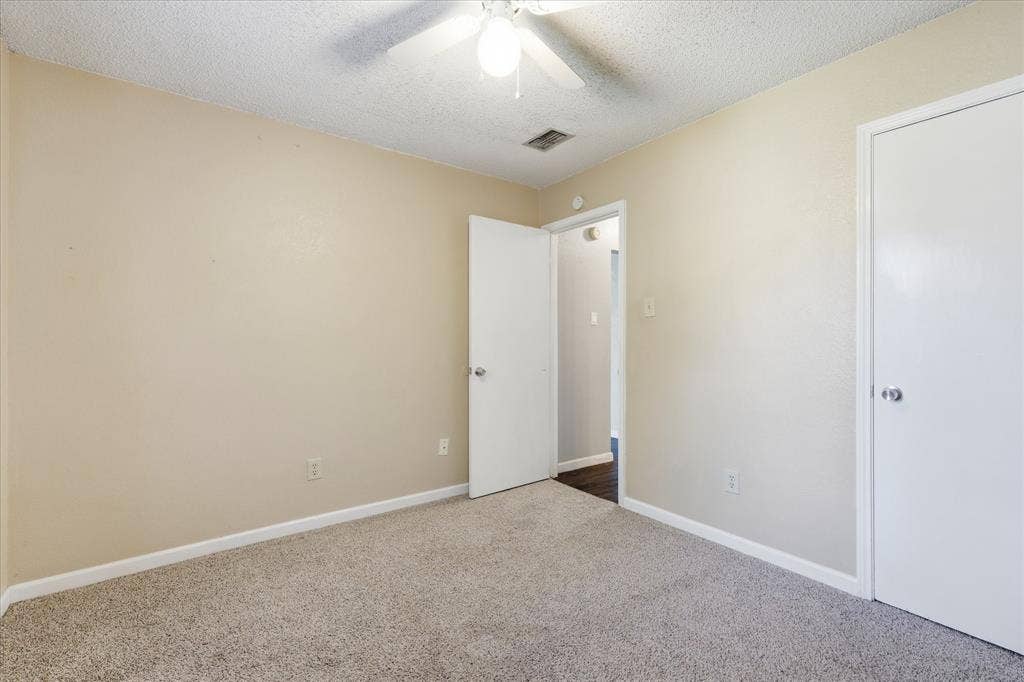 6505 Hughes Drive, Watauga, TX 76148 Carpeted interior space featuring neutral wall tones and white baseboards
