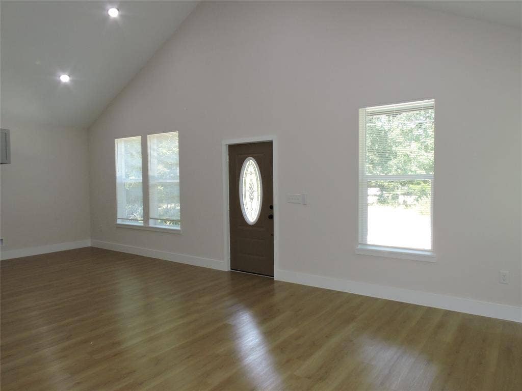 163 Lake Creek Drive, Mabank, TX 75156 Vaulted ceiling with recessed lighting, wood-finish flooring, and white baseboards