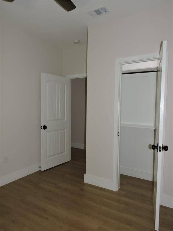 163 Lake Creek Drive, Mabank, TX 75156 Bedroom featuring wood-finish flooring, white baseboards, a ceiling fan, and a built-in closet with a white door