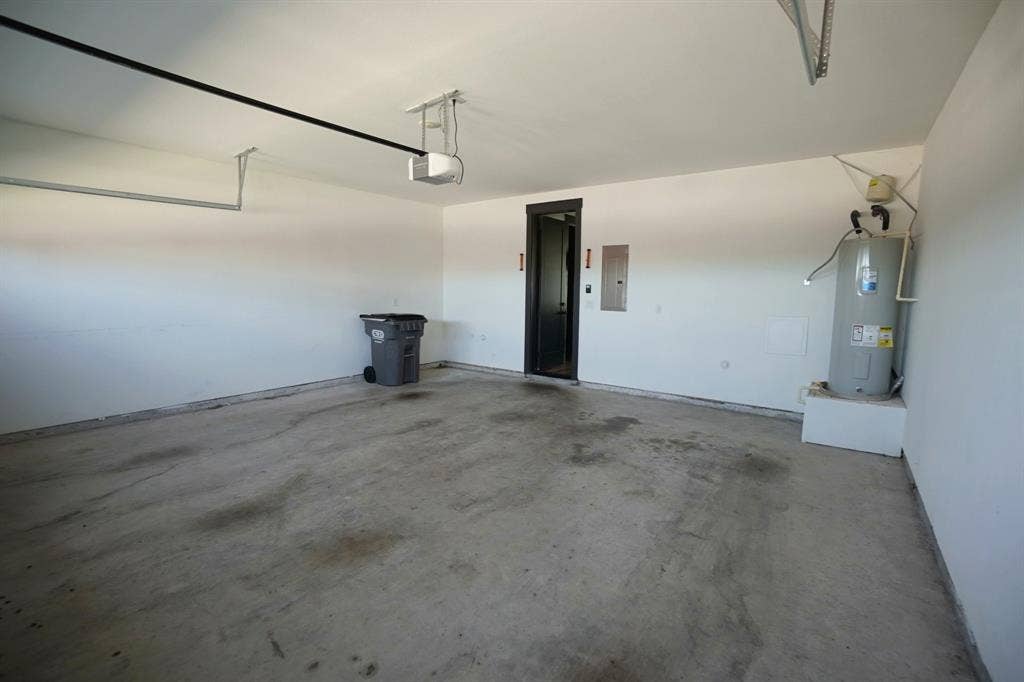 1764 Palladio Loop, Princeton, TX 75407 Enclosed garage with a concrete floor, painted walls, and an interior access door