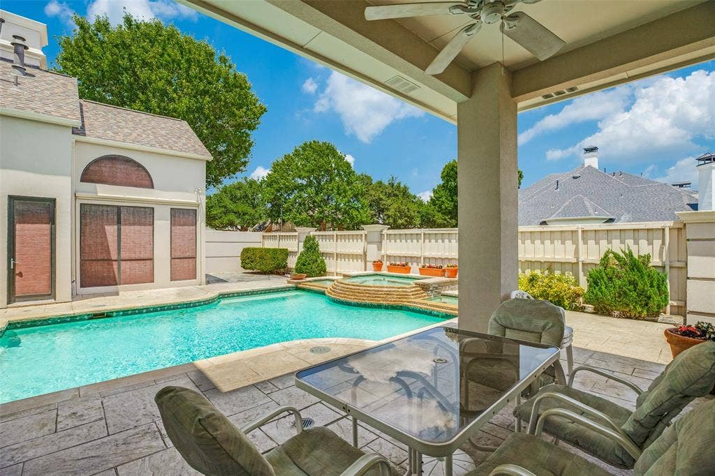5920 Mcfarland Drive, Plano, TX 75093 Covered patio with stamped concrete flooring, ceiling fan, and direct access to the swimming pool and elevated spa