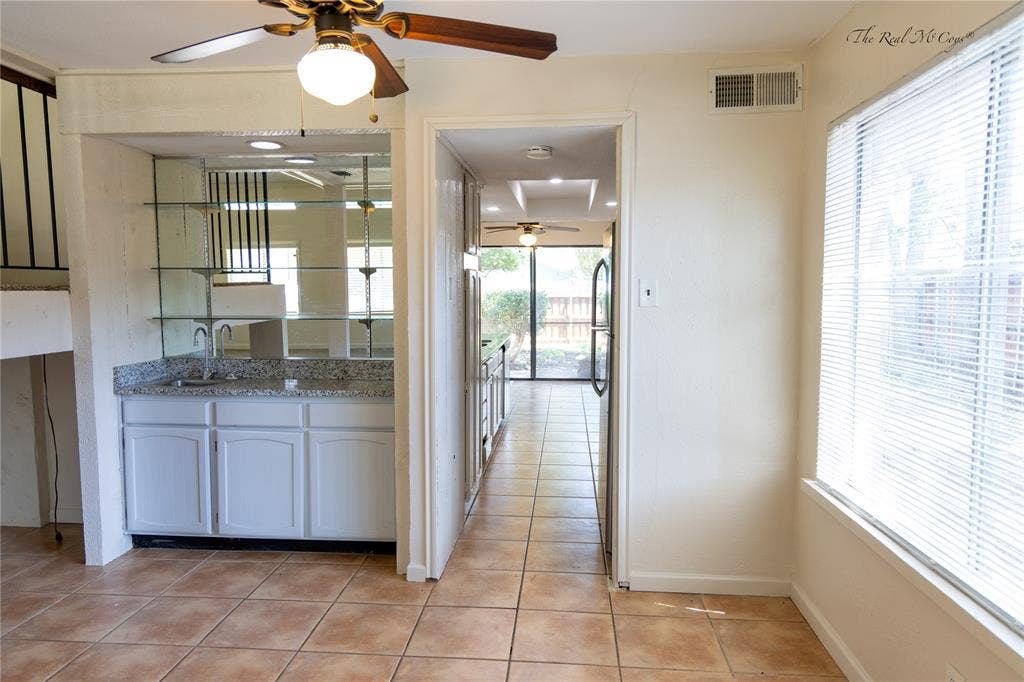 3101 Raintree Drive, Plano, TX 75074 Wet bar in the dining area, with a walk way to the kitchen.