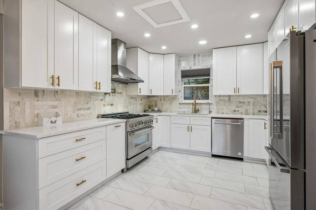 The completely renovated kitchen offers an upscale ZLine Gas Range, Pot Filler, and abundance of cabinets for storage!