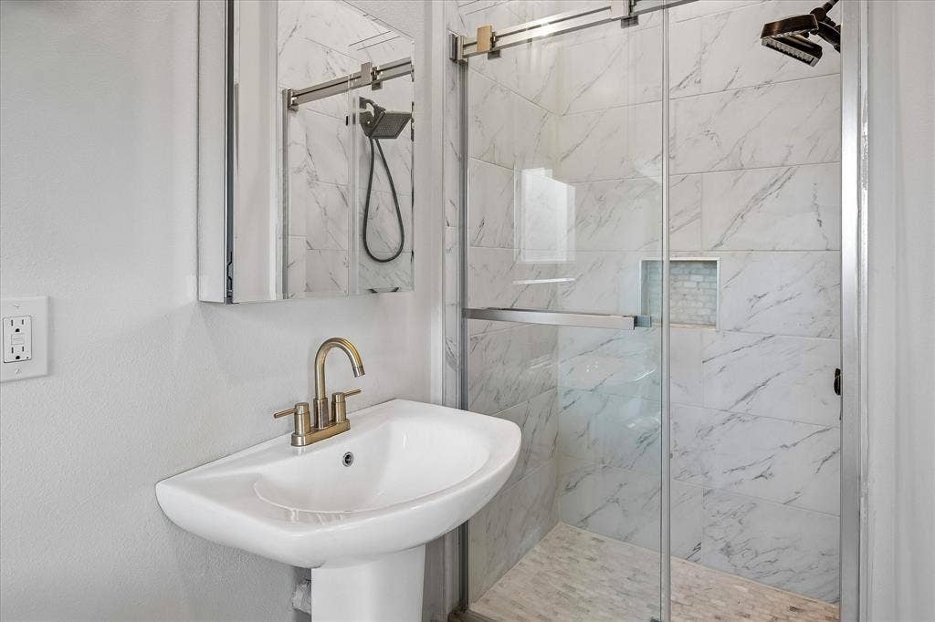 The 2nd Primary Bathroom on the 2nd level has a Pedastal Sink, Shower, and More!