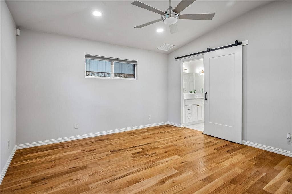 The Primary Bedroom on the 1st Level has an Ensuite with barn-like doors
