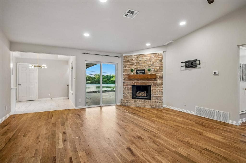 Open to the Breakfast Area and with sliding doors going out to the driveway & patio area with great views of the lake!