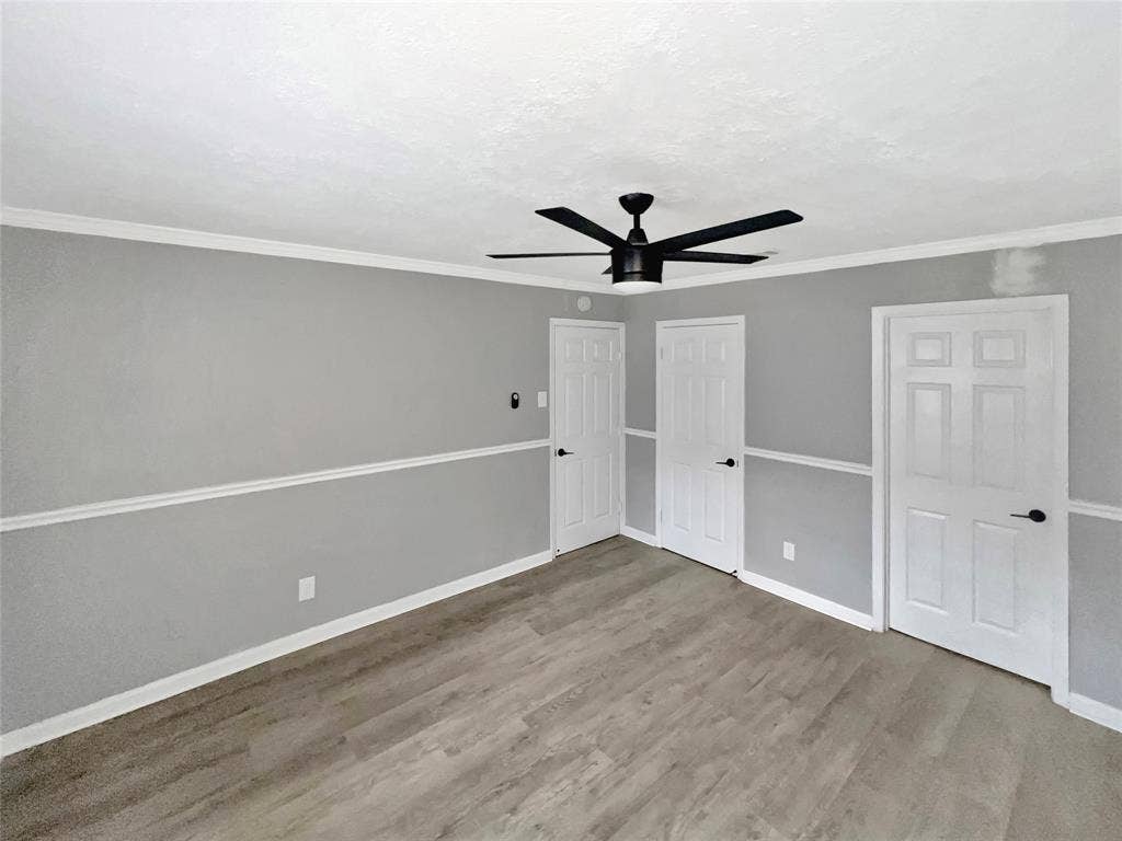 1306 Elby Street, Irving, TX 75061 Room featuring wood-finish flooring and a contemporary black ceiling fan
