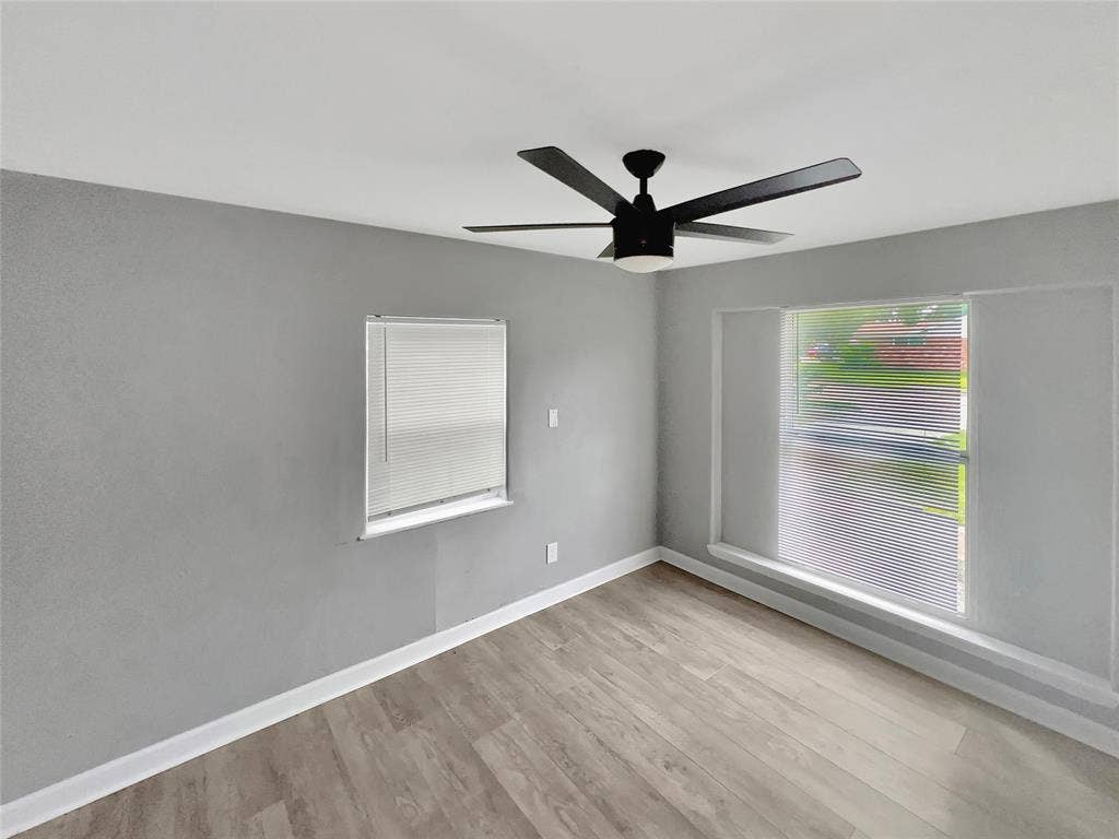 1306 Elby Street, Irving, TX 75061 Room with wood-finish flooring, light grey walls, and a white ceiling