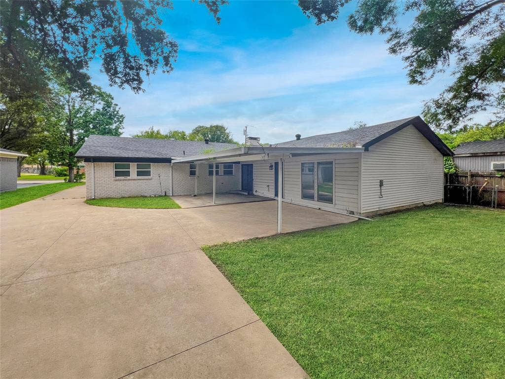 1306 Elby Street, Irving, TX 75061 Expansive concrete patio with an attached covered section
