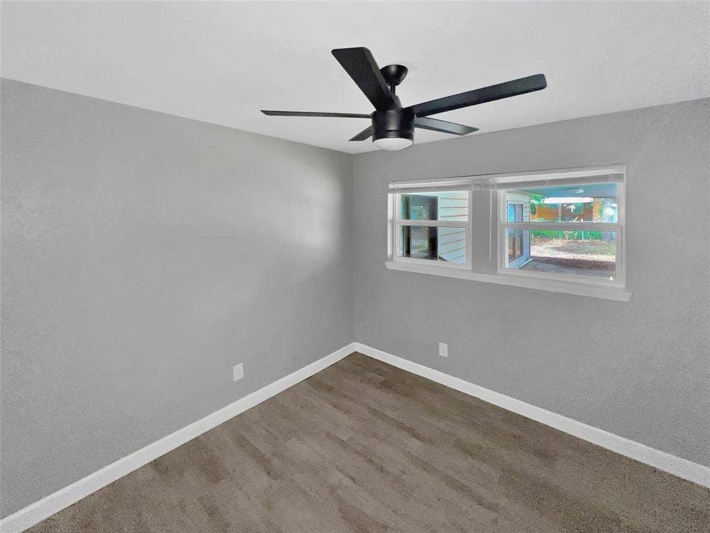 1306 Elby Street, Irving, TX 75061 Room featuring light gray painted walls and wood-finish flooring