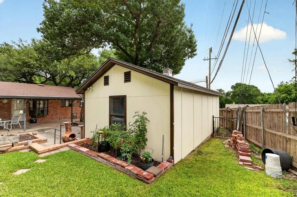 9700 Brookwood Circle, Woodway, TX 76712 Detached accessory building with a gable roof, light-colored siding, and a single window