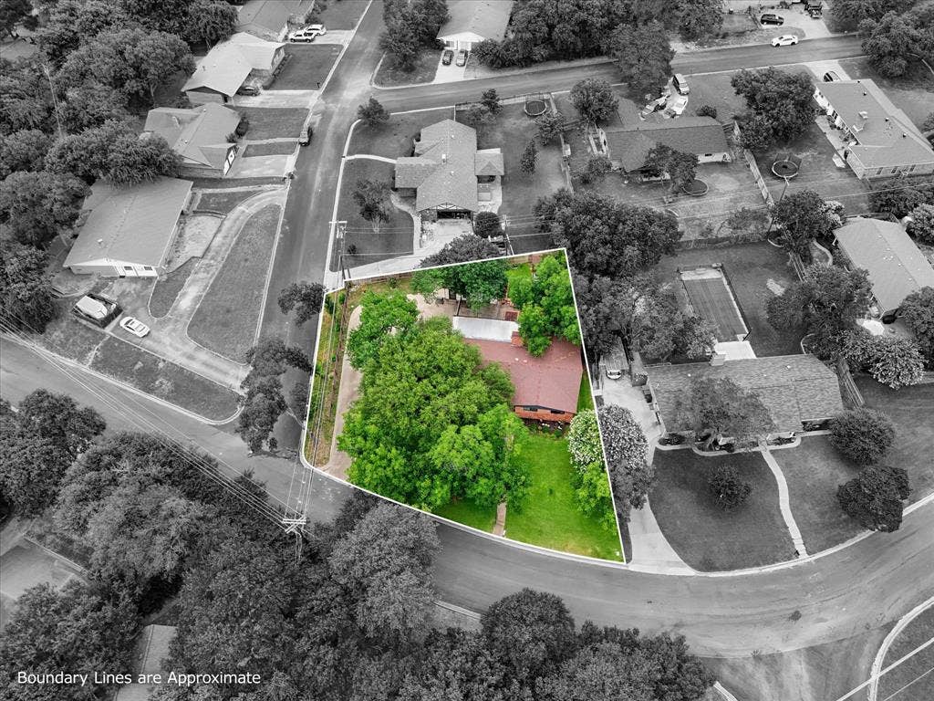 9700 Brookwood Circle, Woodway, TX 76712 Aerial perspective showcasing a corner lot with mature trees, a red-toned roof, and a verdant lawn