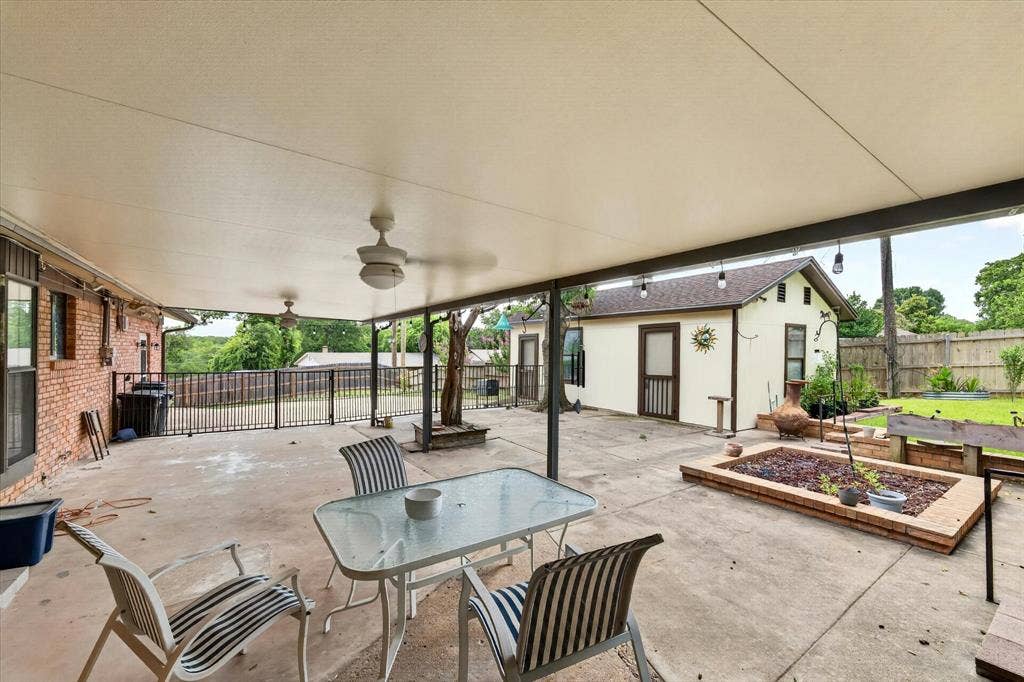 9700 Brookwood Circle, Woodway, TX 76712 Expansive covered patio featuring two ceiling fans and concrete flooring