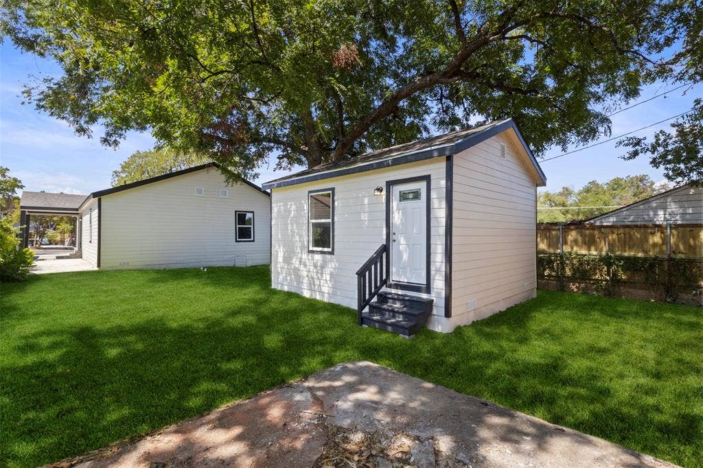 1104 S Brighton Avenue, Dallas, TX 75208 Detached structure with white siding, dark trim, and a private entrance