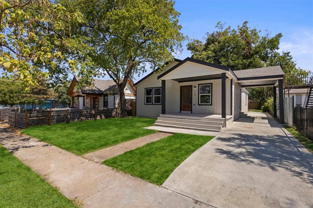 1104 S Brighton Avenue, Dallas, TX 75208 Contemporary exterior with a covered front porch, carport, and concrete driveway