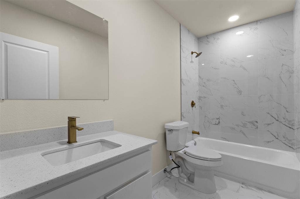 1104 S Brighton Avenue, Dallas, TX 75208 Modern vanity with an integrated rectangular sink and gold-finish faucet