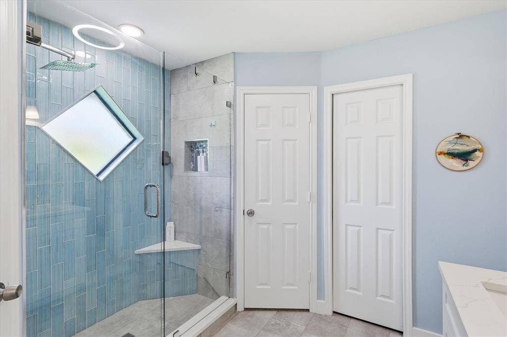 642 Eagle Drive, Coppell, TX 75019 Shower features a soap niche and an angled shelf.