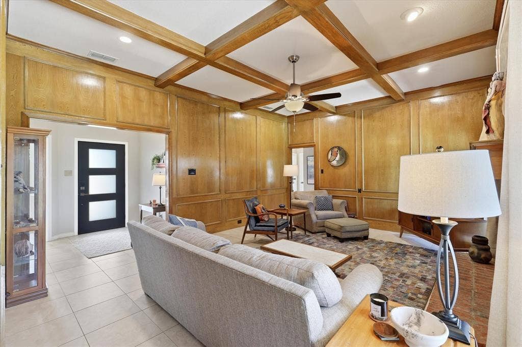 642 Eagle Drive, Coppell, TX 75019 Picture frame paneling and decorative beams make this a warm and cozy living space.