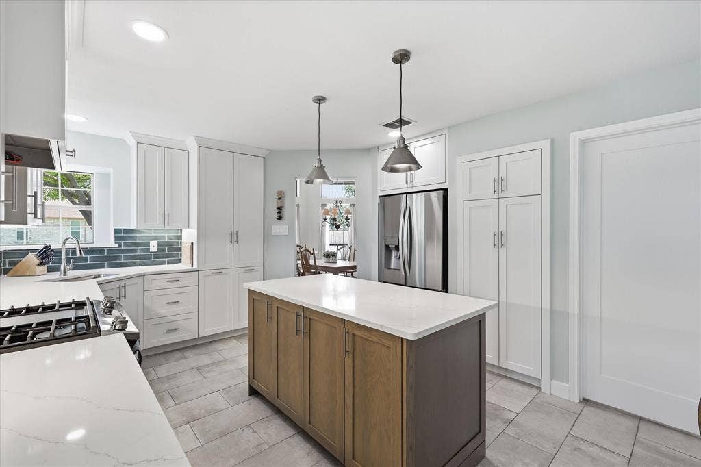 642 Eagle Drive, Coppell, TX 75019 Remodeled kitchen offers an appliance garage and pantry. 42" cabinet uppers allow for much additional storage. Next to the refrigerator is the built in pantry.