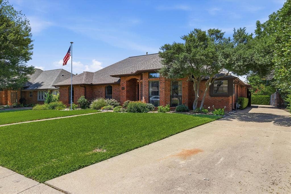 642 Eagle Drive, Coppell, TX 75019 Long driveway with swing in parking in the back and an electric gate.
