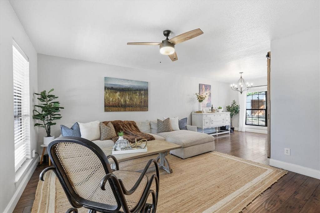 513 Fox Creek Court, Denton, TX 76209 This gorgeous light filled living room features wood floors and serenity.
