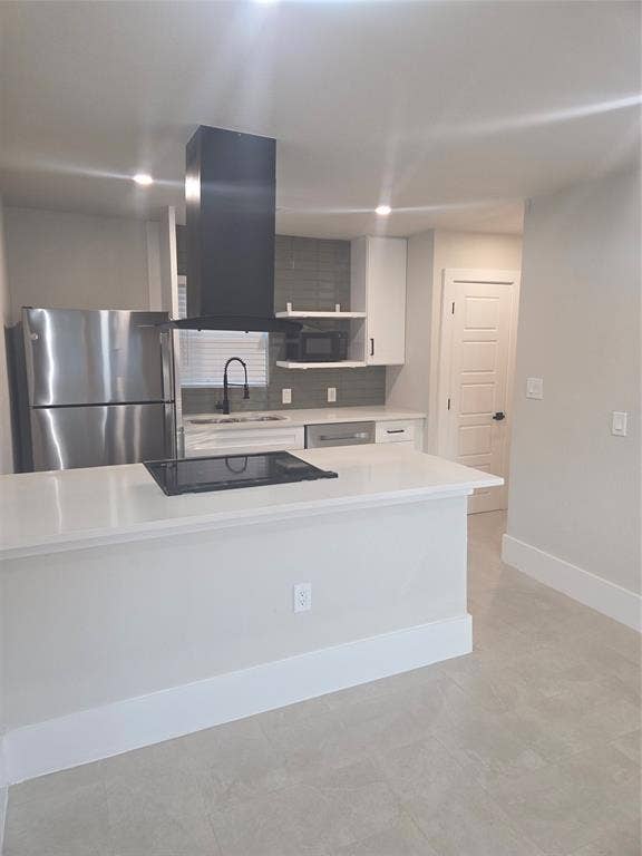 2329 Cass Street, Fort Worth, TX 76112 Modern kitchen featuring a stainless steel refrigerator, white cabinetry, integrated cooktop, and a matte black range hood
