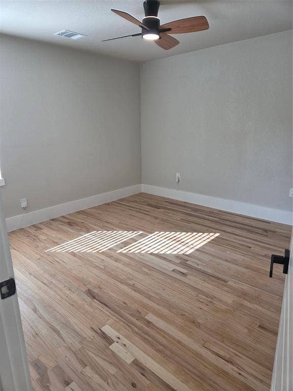 2329 Cass Street, Fort Worth, TX 76112 Spacious room featuring wood-finish flooring, light gray wall paint, and white baseboards
