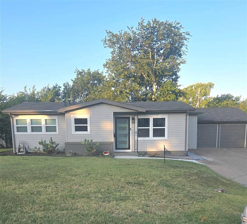 2329 Cass Street, Fort Worth, TX 76112 Single-story residence featuring light gray siding and a dark gray roof