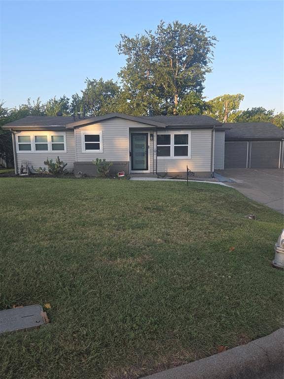 2329 Cass Street, Fort Worth, TX 76112 Single-story home featuring light-colored siding, a dark roof, and a two-car garage