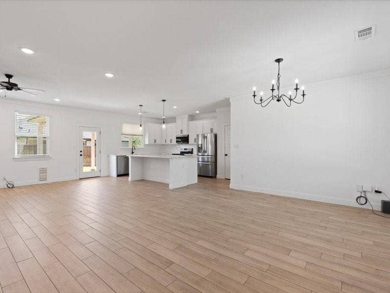 5528 Mesa Loop, Granbury, TX 76048 Open-concept living space featuring wood-look tile flooring and white walls