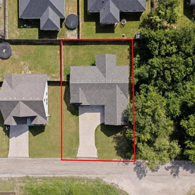 5528 Mesa Loop, Granbury, TX 76048 Aerial view showcasing a residential property with a gray shingle roof, a concrete driveway, and an expansive grass lawn