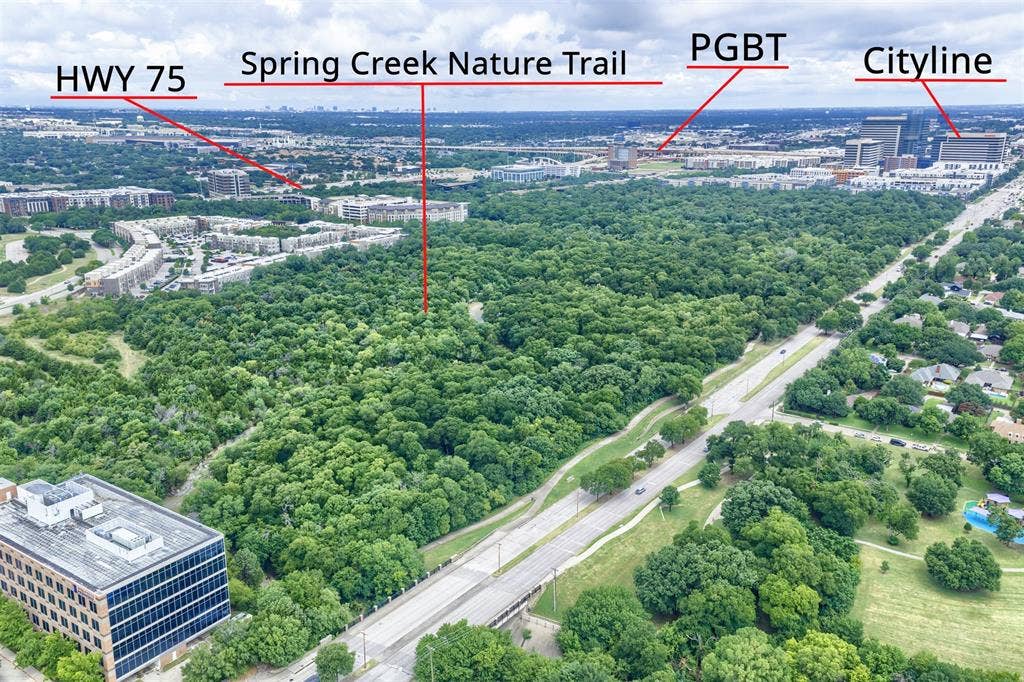 1717 Whitney Drive, Richardson, TX 75082 Aerial perspective showcasing a dense urban forest, a major thoroughfare, and commercial structures