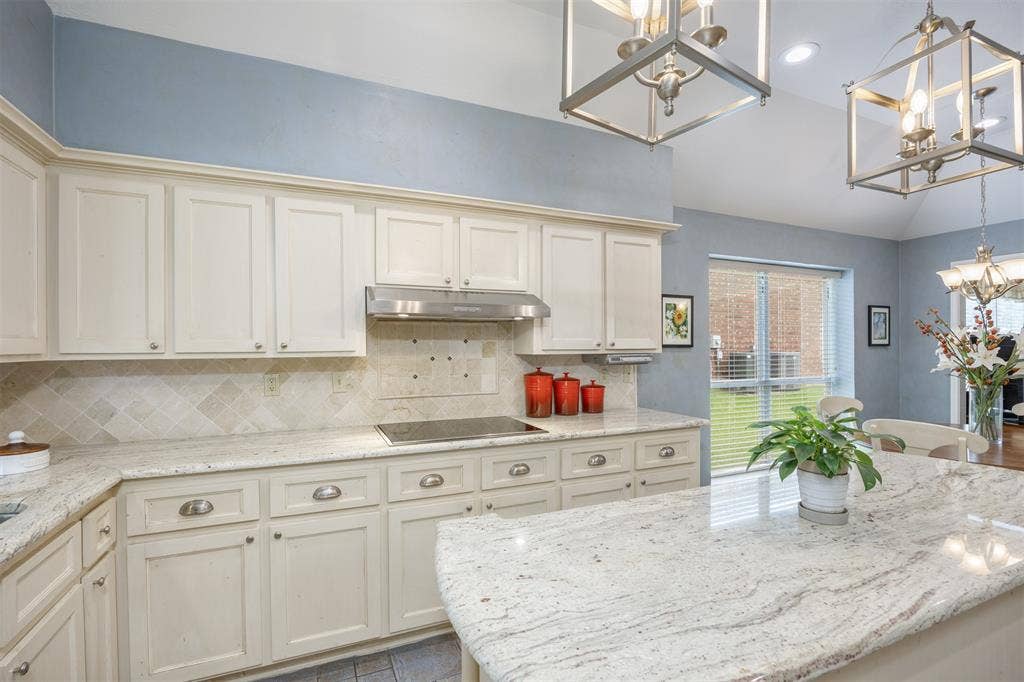 1717 Whitney Drive, Richardson, TX 75082 Kitchen featuring white cabinetry, light-toned countertops, a tile backsplash, and a built-in cooktop with a range hood
