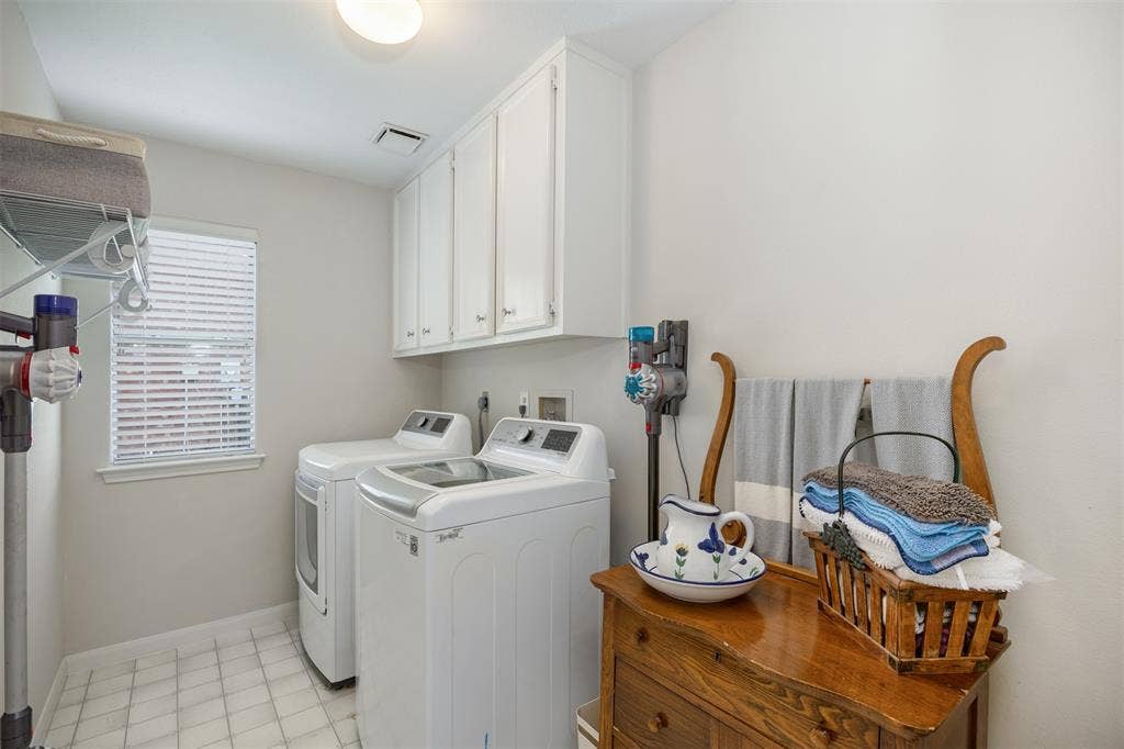 1717 Whitney Drive, Richardson, TX 75082 Dedicated laundry room featuring white cabinetry, a window with blinds, and tile flooring