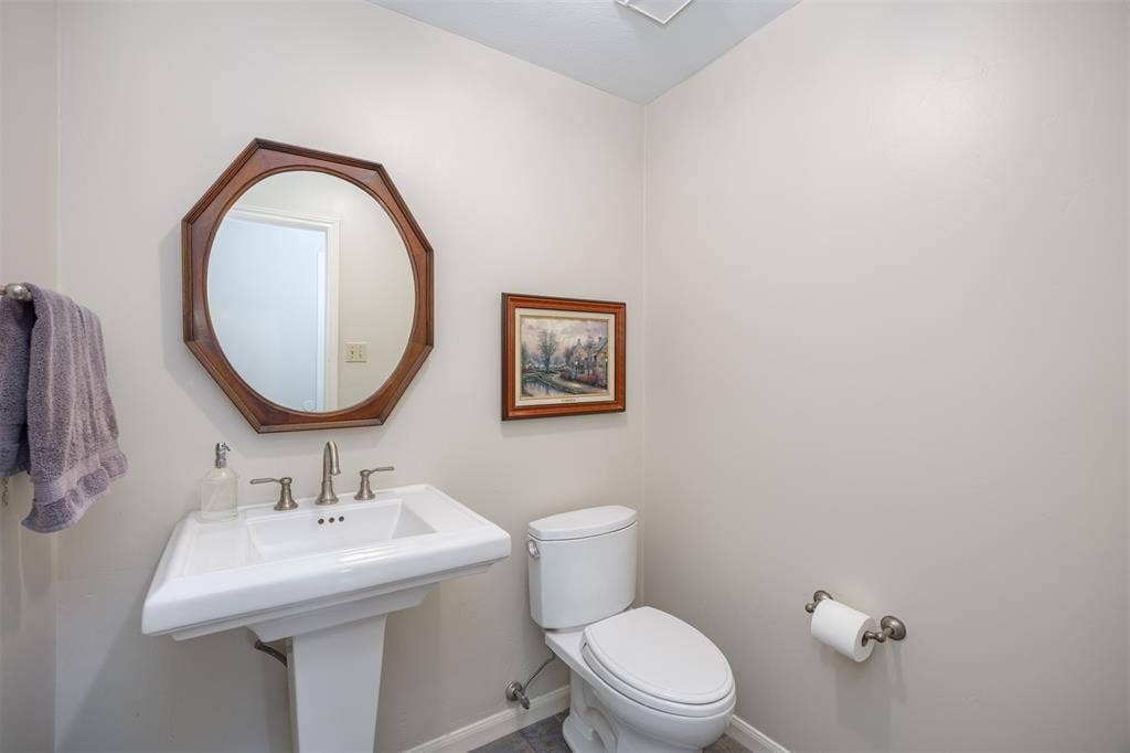 1717 Whitney Drive, Richardson, TX 75082 Pedestal sink featuring a chrome faucet
