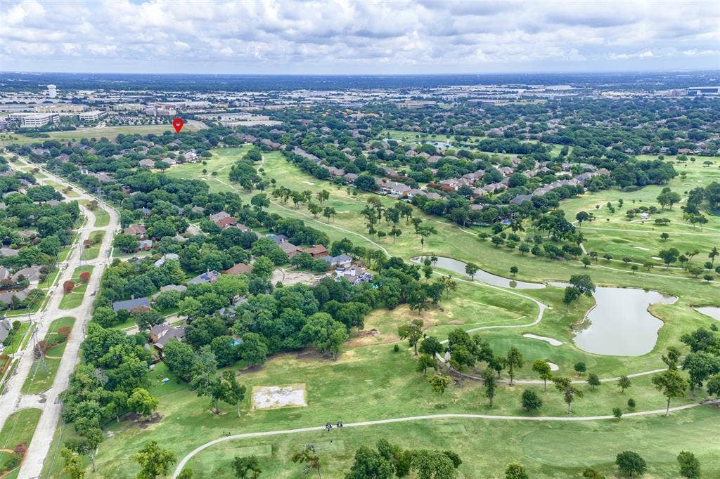 1717 Whitney Drive, Richardson, TX 75082 Expansive golf course property featuring multiple fairways, water features, and abundant mature trees