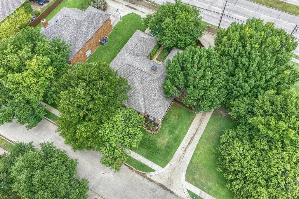 1717 Whitney Drive, Richardson, TX 75082 Aerial perspective showcasing a property featuring a shingle roof and brick exterior