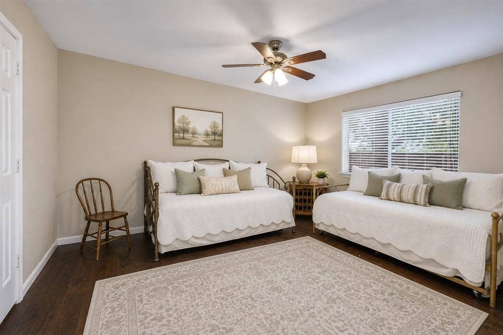 1717 Whitney Drive, Richardson, TX 75082 Spacious room featuring wood-finish flooring, a ceiling fan with integrated lighting, and a large window with privacy blinds
