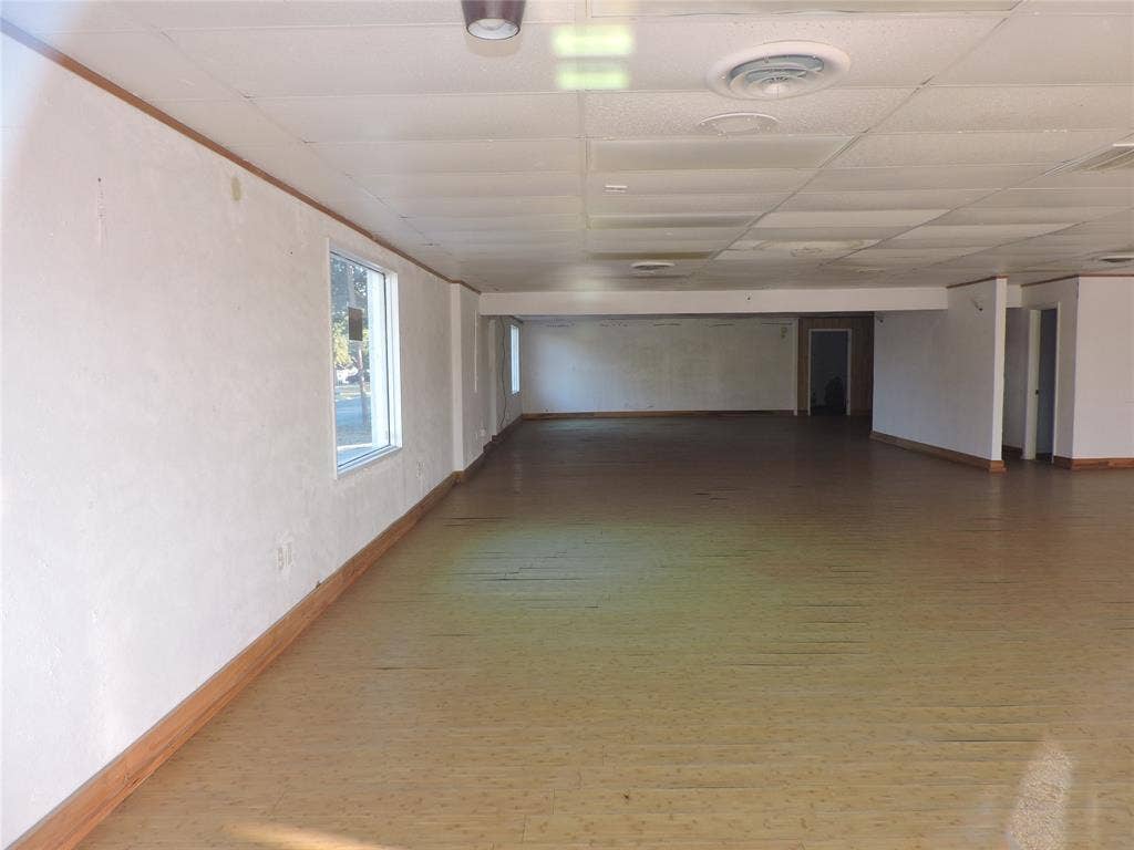 5149 River Oaks Boulevard, River Oaks, TX 76114 Spare room featuring wood finished floors and a drop ceiling