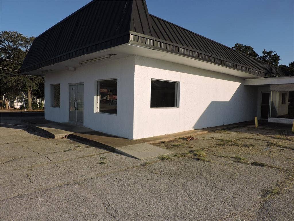 5149 River Oaks Boulevard, River Oaks, TX 76114 View of side of home with stucco siding, a metal roof, and a patio